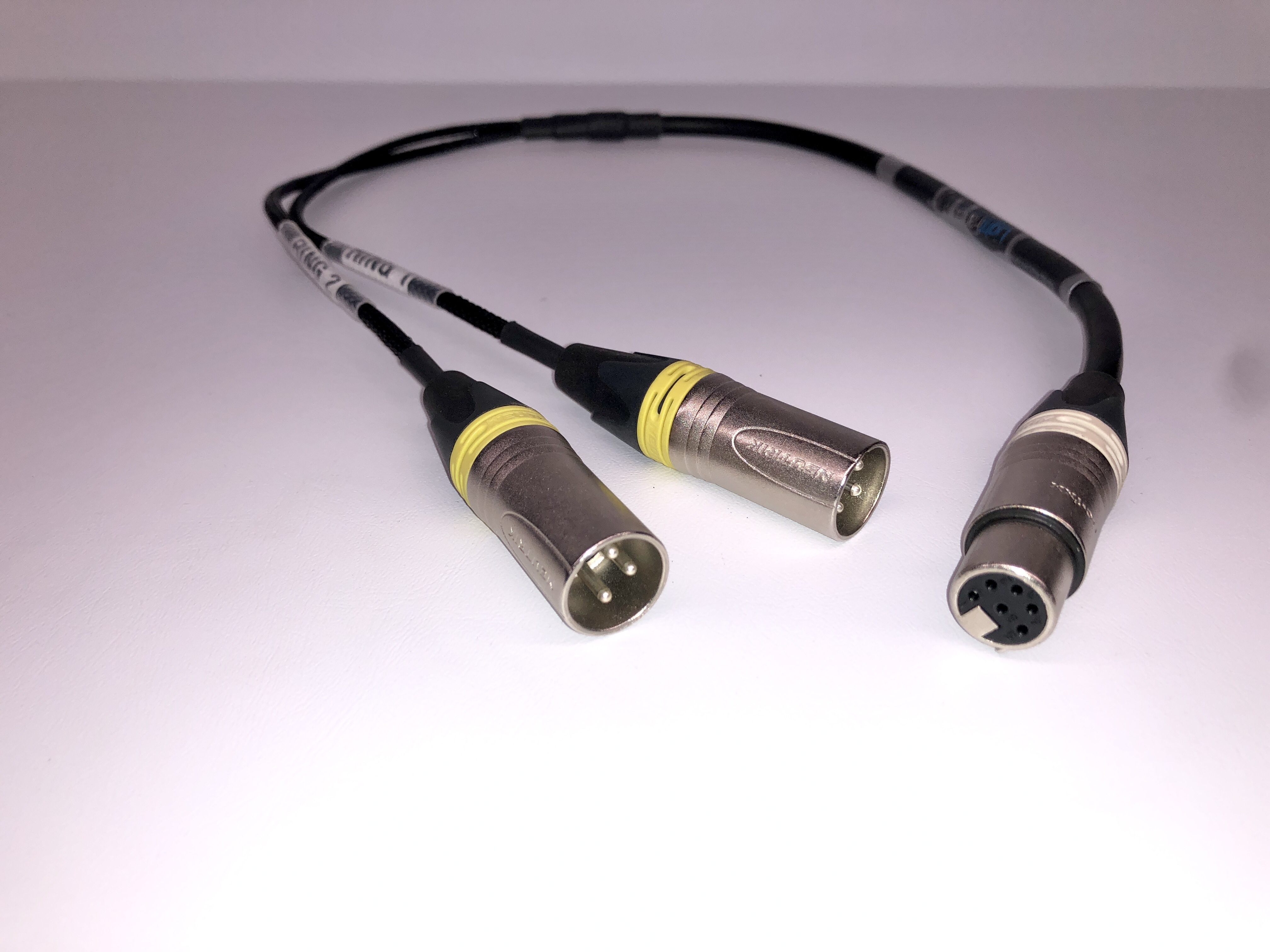 Tall slender porcelain bottle with natural clay textured body and cork stopper.